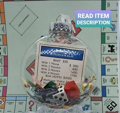 a glass ornament filled with lots of dices and other items on top of a board game