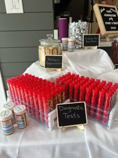 a table topped with lots of red cups filled with liquid