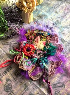 there are many different colored flowers on the table cloth, and one is holding a woman's face