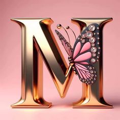 the letter m is made up of gold letters and a butterfly with jewels on it