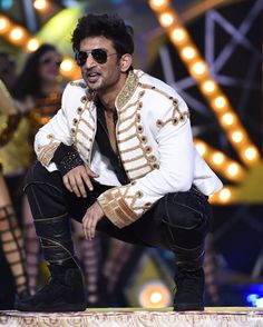 an image of a man that is in the middle of a dance pose on stage