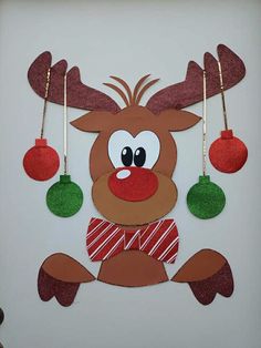 a paper reindeer with christmas ornaments hanging from it's antlers on the wall