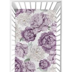 a purple and white flowered crib sheet