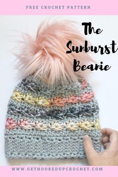 a crocheted hat with pink pom - pom in the center and text overlay that reads, the sunburst beanie free crochet pattern