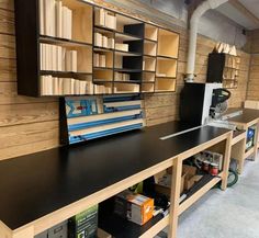 a long table with many books on it in a room filled with shelves and other items