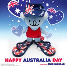 a stuffed animal with australia day on it's face and shoes in the foreground