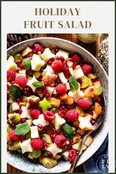 a bowl filled with fruit salad on top of a table