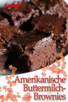 a chocolate cake on a white plate with flowers around the edges and an advertisement for brownies