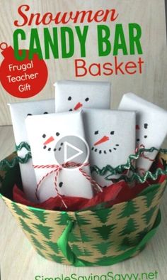 a basket filled with marshmallows and snowmen candy bar gift wrappers