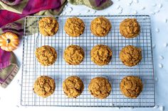 pumpkin spiced cookies cooling on a wire rack next to a purple and white towel