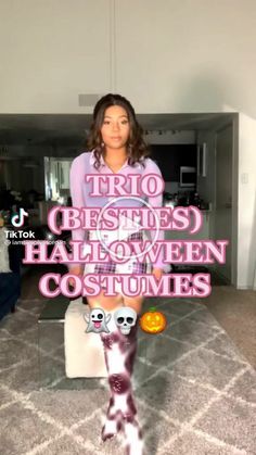 a woman sitting on top of a white couch in front of a tv screen with the words trio dressed halloween costumes