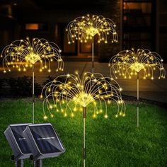 three solar powered garden stake lights in the grass