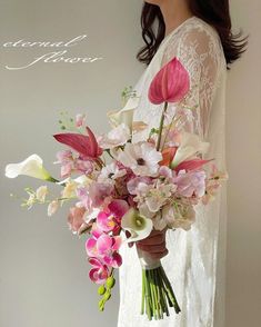 a woman holding a bouquet of flowers in her hands