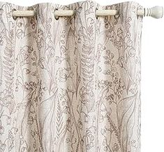 the curtain is closed and ready to be hung in front of a white background with floral designs