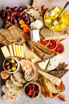 an assortment of cheeses, crackers and fruit