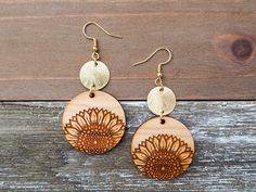 These wooden sunflower earrings carry a beautiful sunny and natural vibe. Their details are stunning, and they are so comfortable to wear as they are lightweight and of course hypoallergenic! Please note that the sunflower design is only on one side of the pendant and the other side is beautiful, natural wood. :)   ♡ Materials info & color options The pendants are laser cut from natural, real wood. For the connector disc, you have the option to choose a silver-colored or a gold-colored disc, both with a brushed finish. All of the earring hook options are hypoallergenic to keep sensitive skin happy. You can choose from silver-colored or gold-colored hooks or real 925 sterling silver hooks for your earrings as shown in the listing photos. Simply make your customization choices in this listin Sunflower Dangle Earrings For Summer, Sunflower Design Drop Earrings For Summer, Bohemian Sunflower Design Jewelry For Summer, Bohemian Summer Jewelry With Sunflower Design, Bohemian Sunflower Design Summer Jewelry, Bohemian Sunflower Drop Earrings, Bohemian Sunflower Design Flower Earrings As Gift, Bohemian Sunflower Earrings For Gift, Bohemian Sunflower Earrings As Gift