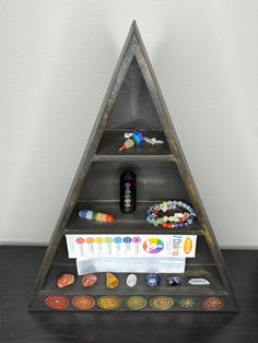 a triangle shaped shelf with various items on it