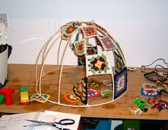 a wooden table topped with lots of crafting supplies and paper work on top of it