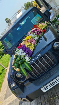 flowers are placed on the hood of a car