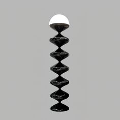 a black and white photo of a light fixture in the air with an egg hanging from it's side