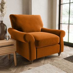 an orange chair sitting on top of a wooden floor