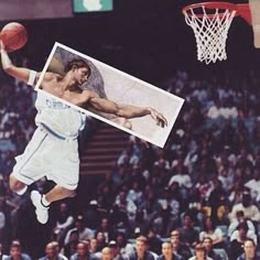 a basketball player jumping up into the air to dunk a ball in front of an audience