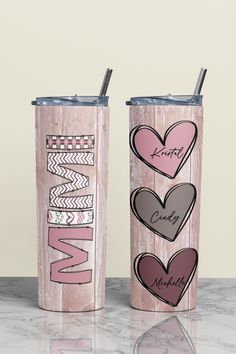 two personalized tumblers with hearts and the word grandma on them are sitting next to each other