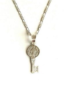 "925 STERLING SILVER SAINT BENEDICT KEY NECKLACE . 20\" LONG FÍGARO CHAIN. FOR GOOD LUCK ,PROSPERITY AND PROTECTION. PENDANT SIZE 22 mm X 8 mm CADENA DE 925 PLATA ESTERLINA SAN BENITO LLAVE. CADENA 20\" LARGO FIGARO. PARA BUENA SUERTE ,PROSPERIDAD Y PROTECCIÓN... TAMAÑO DEL DIJE : 22 mm X 8 mm" Silver Key Pendant Jewelry, Silver Pendant Necklace With Two Keys, Silver Key Necklace For Gift, Silver Key Pendant Necklace, Silver Engraved Charm Necklace For Good Luck, Good Luck Silver Engraved Charm Necklaces, Good Luck Silver Engraved Charm Necklace, Silver Necklace With Two Keys For Gift, Personalized Silver Jewelry For Good Luck