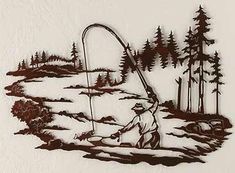 a metal artwork depicting a man fishing in the woods