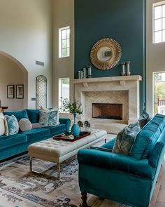 a living room filled with furniture and a fire place in the middle of a room