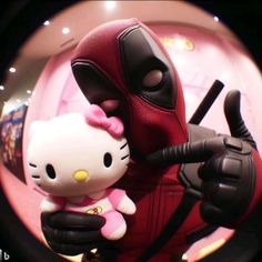 a hello kitty doll is posed next to a deadpool