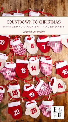 a wooden table topped with lots of red and white christmas stocking hanging from clothes