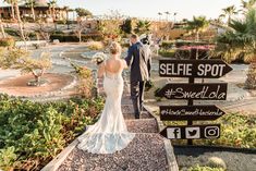 a bride and groom are walking up the stairs to their wedding reception at selfie spot