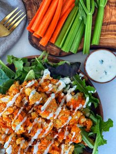 a plate with carrots, celery and other vegetables on it next to some ranch dressing