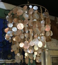 a chandelier made out of coins hanging from the ceiling