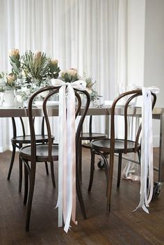 the table is decorated with flowers and ribbons