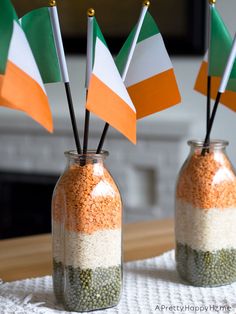 two mason jars filled with rice and flags