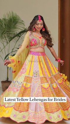 a woman in a yellow and pink lehenga