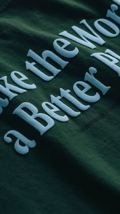 a green t - shirt with the words make the world a better place on it