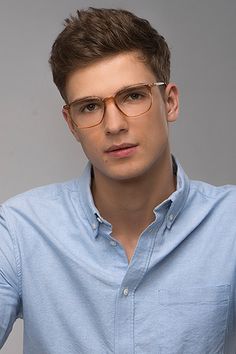 a man wearing glasses is posing for the camera