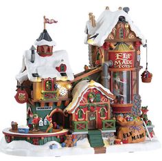 a small christmas village is shown in the snow