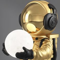 an astronaut in gold holding a white frisbee with headphones on his ears