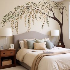 a bedroom with a large tree painted on the wall and bed in front of it