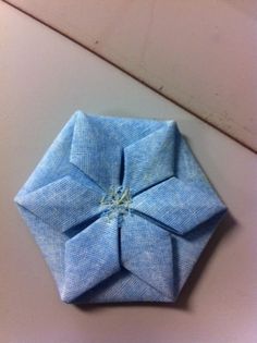 an origami flower sitting on top of a table