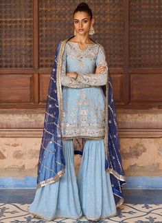 a woman in a blue outfit posing for the camera