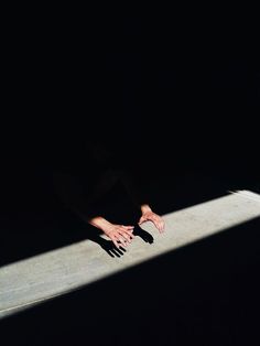 the shadow of a person's hand on a skateboard