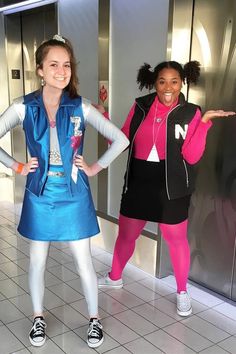 two girls in costumes standing next to each other