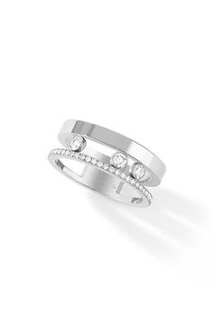 a white gold ring with diamonds on the side and two stones in the middle,