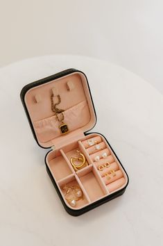 The Kristen Jewelry Case comes in many colors, so there's sure to be one for everyone! This perfectly-sized jewelry box is a space-saving solution that's easy to slide in your suitcase or to keep on display at home. It features three necklace hooks, ring slots, and adjustable slots for added organization.  It's the perfect gift for everyone on Valentines Day, Easter, Mother's Day, Birthdays, and Christmas. Be sure to grab one for yourself, too!   Details:  3.75" long x 3.75" wide x 2" tall Vegan leather Silver hardware