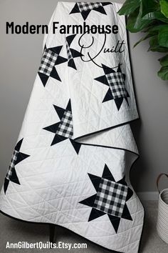 a black and white quilt with the words modern farmhouse quilts written in cursive font